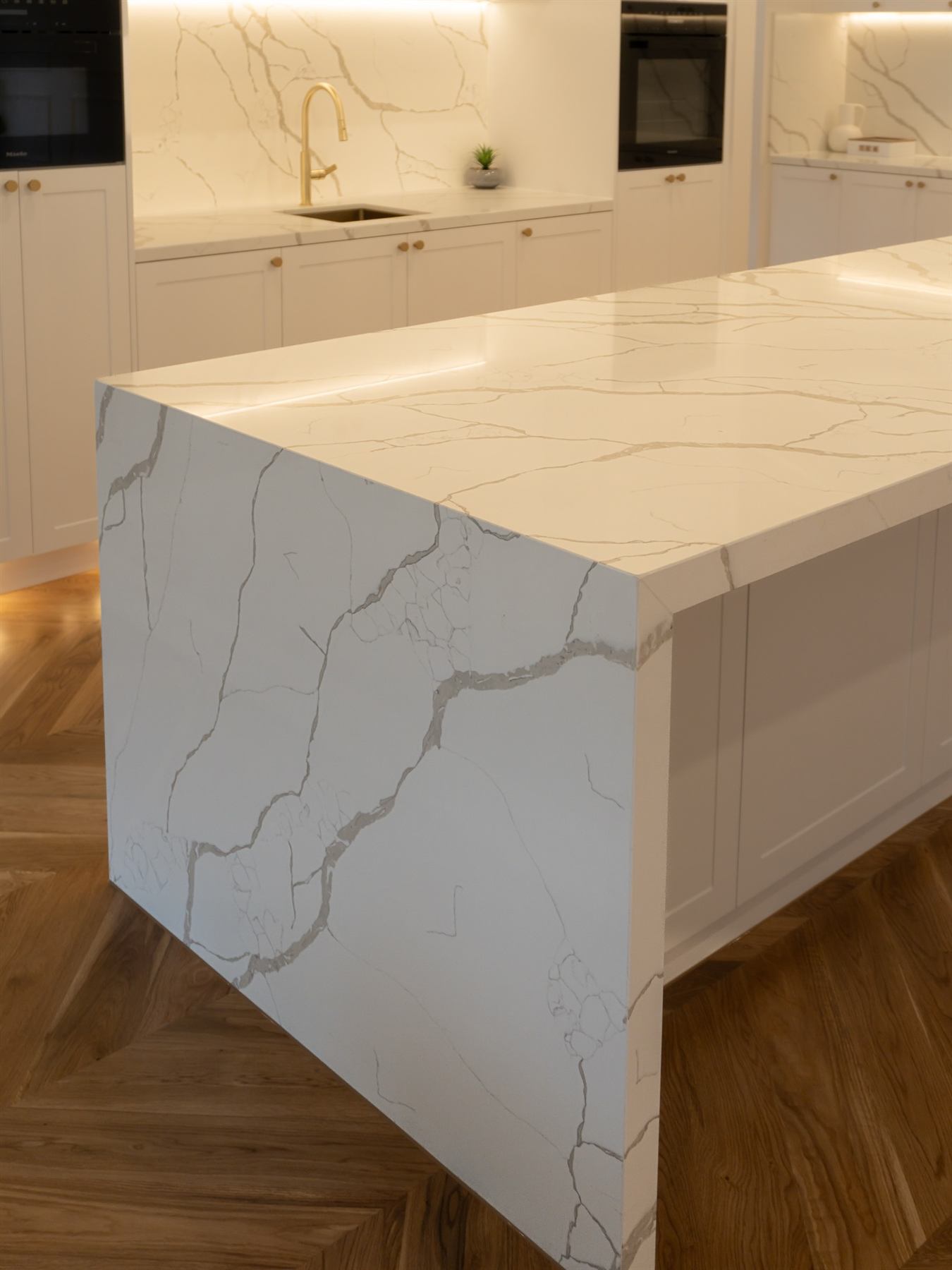 Calacatta Laza stone kitchen island waterfall edge with vein matching